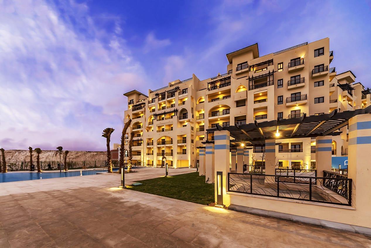 ALDAU Heights apartment buildings beside landscaped grounds