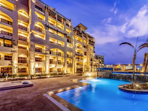 ALDAU Heights Hurghada swimming pool and golden apartment facade