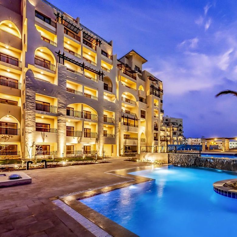 ALDAU Heights Hurghada swimming pool and golden apartment facade
