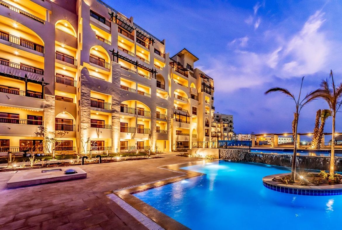 ALDAU Heights resort apartments beside an illuminated pool