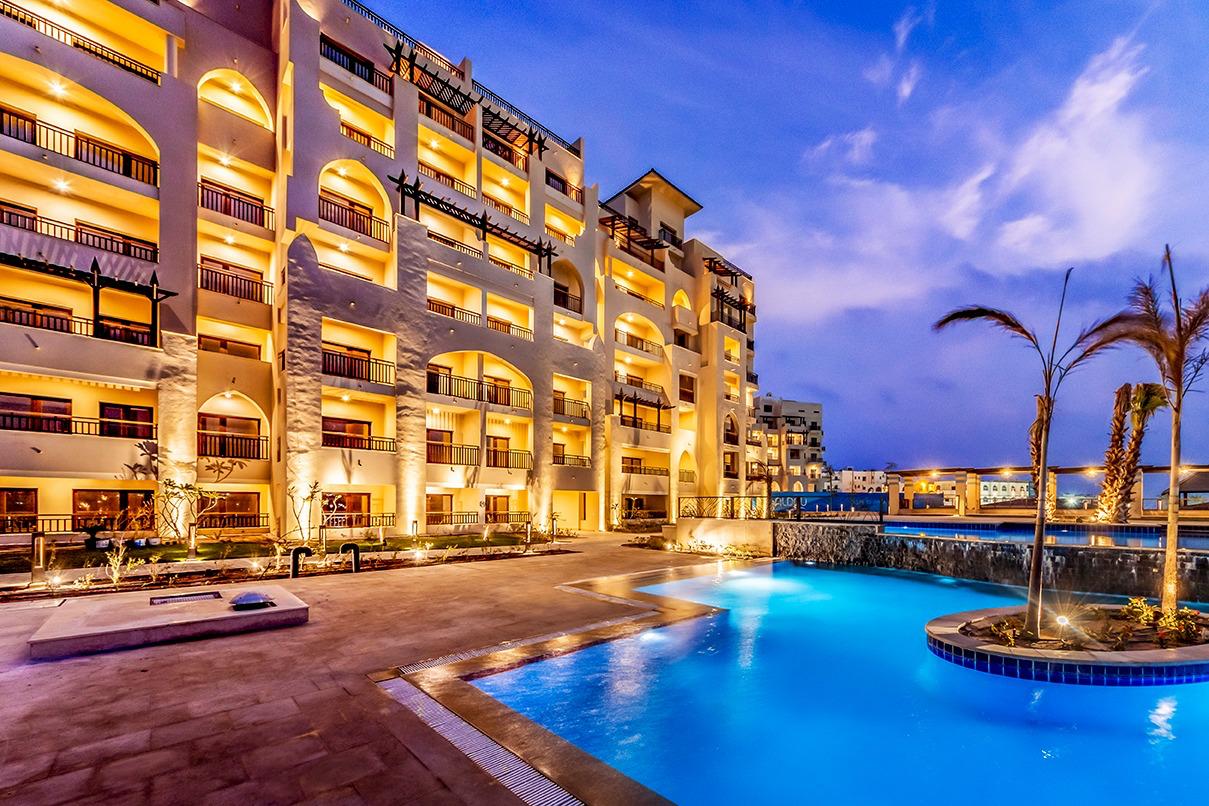 ALDAU Heights resort apartments beside an illuminated pool